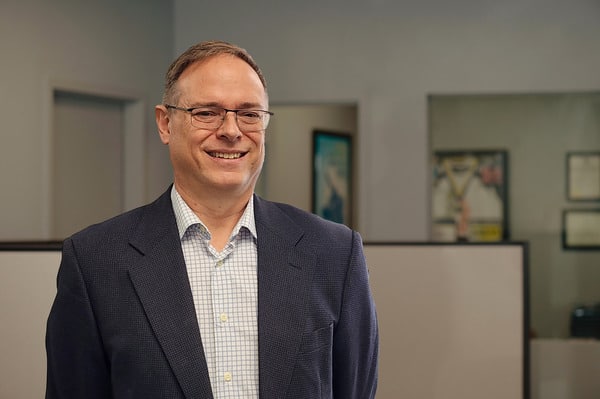 headshot of Richard winton with phots in the background