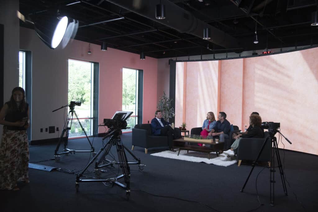 XO Marriage media area with people having an interview