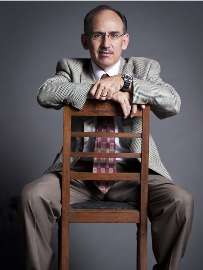 man sitting on a backwards chair