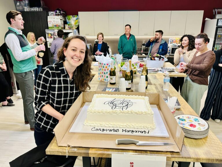 people celebrating a new architect license with a cake