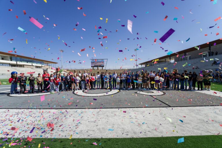 crowd celebrating at Socorro ISD's new football stadium with confetti
